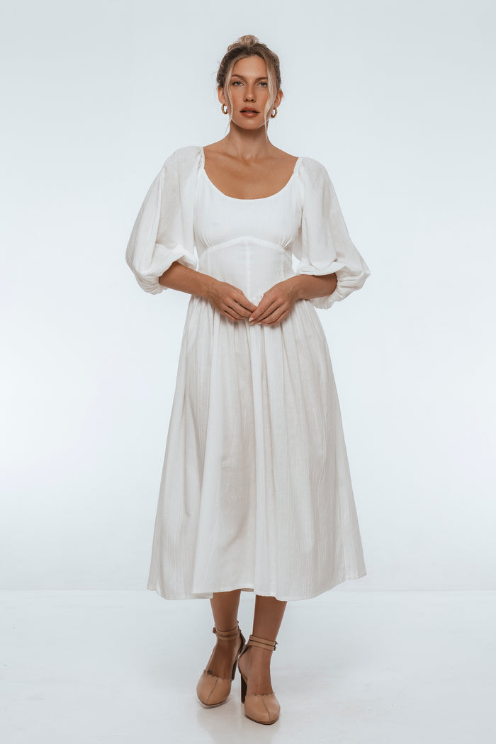 Woman wearing a white dress on a white background
