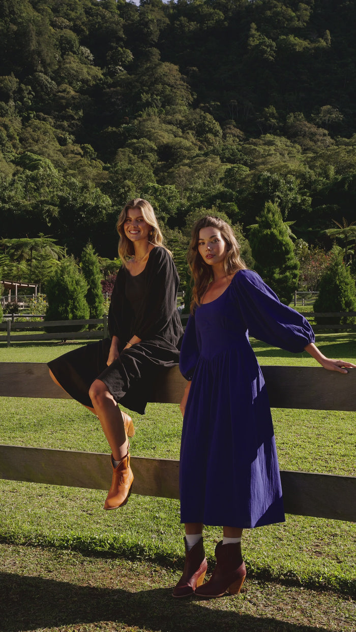 Video of models wearing handmade linen dress in midi length with puff sleeves