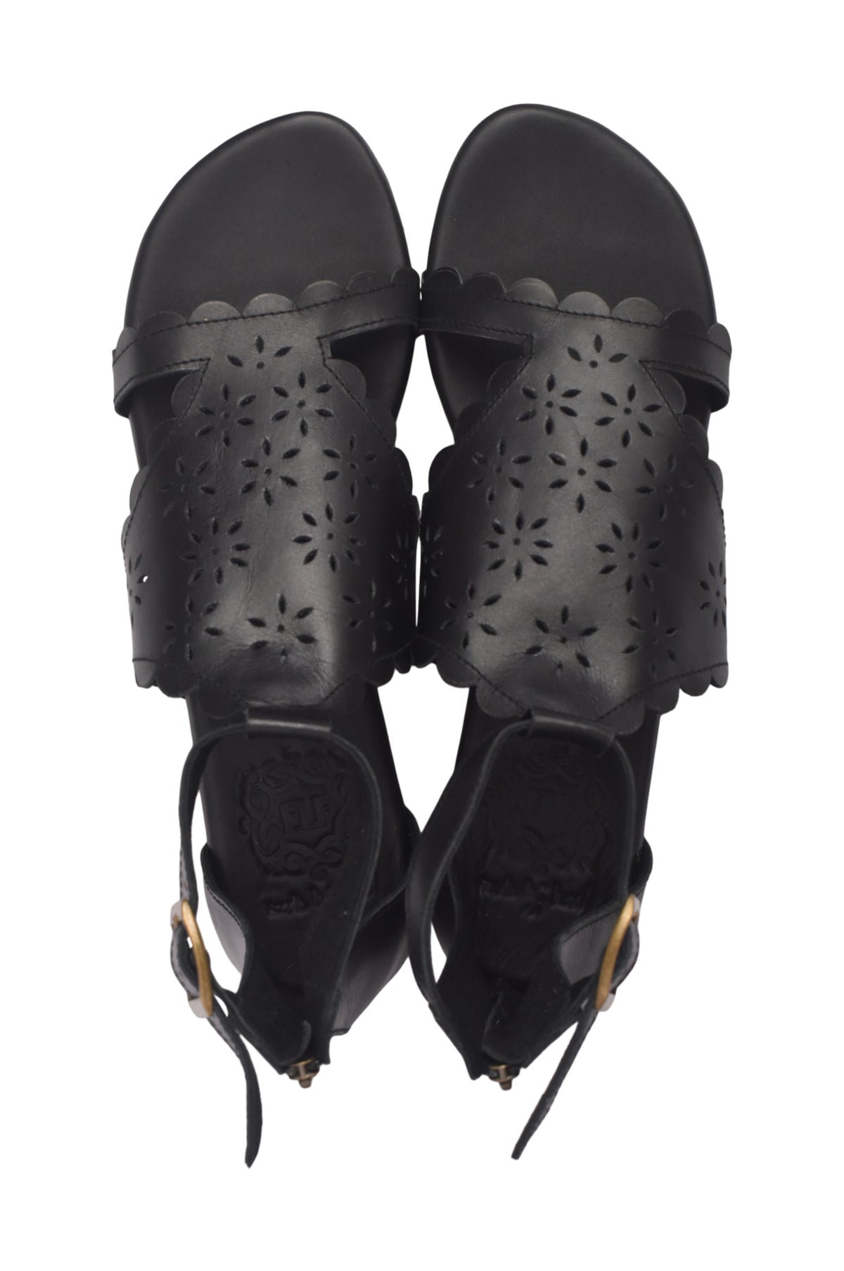 A pair of black leather slide sandals with floral laser-cutout details on the straps and scalloped edges, shown from a top-down view on a white background.