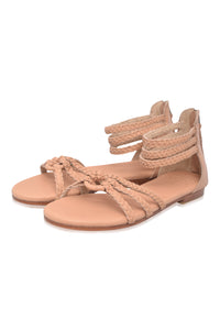 Beige sandals with braided straps on a white background