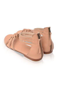 Pair of tan sandals on a white background