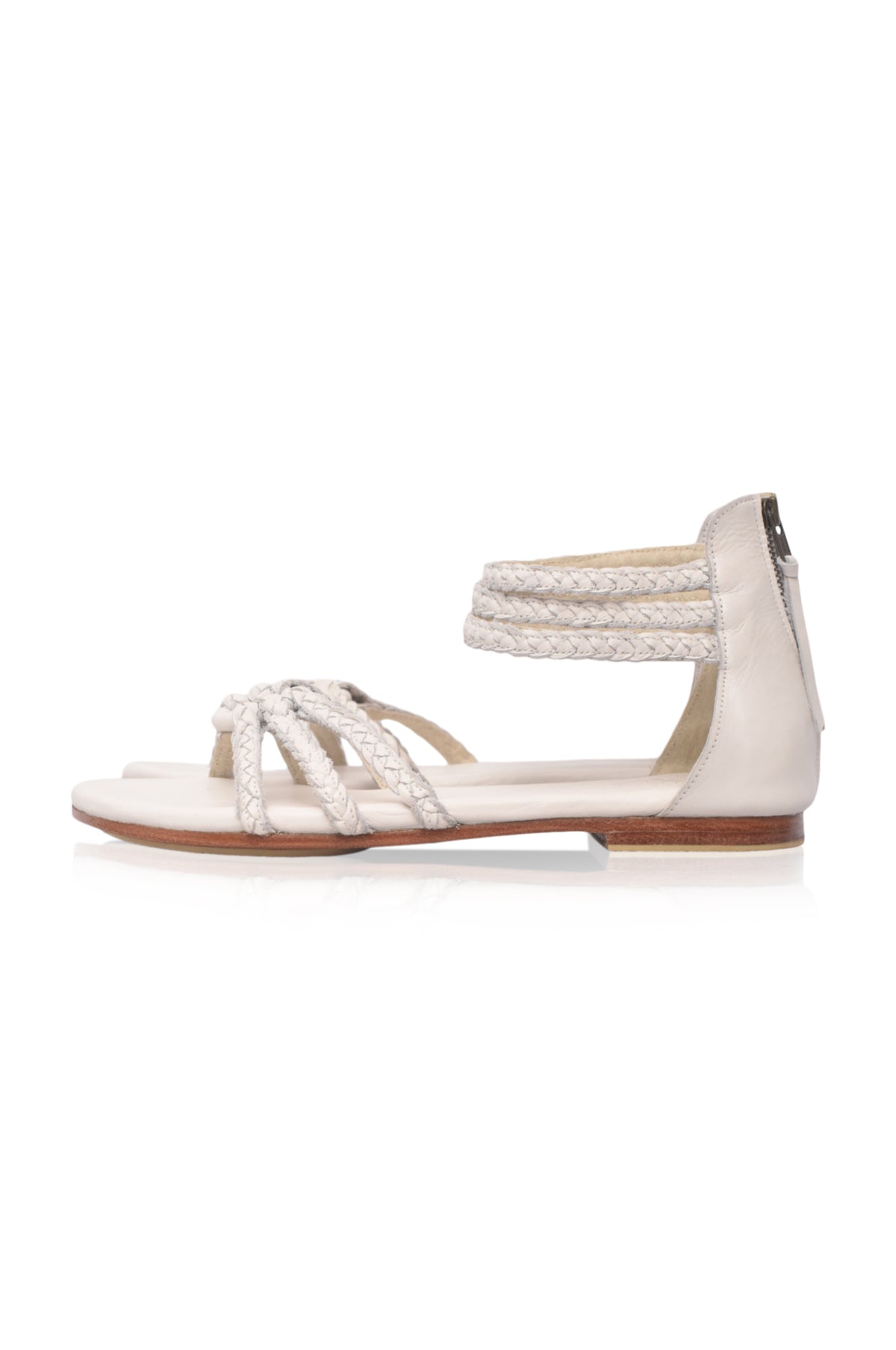 White sandal with braided details on a white background