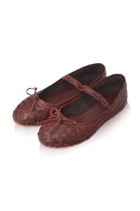 A pair of dark brown woven leather ballet flats with Mary Jane straps and bow details, displayed on a clean white background.