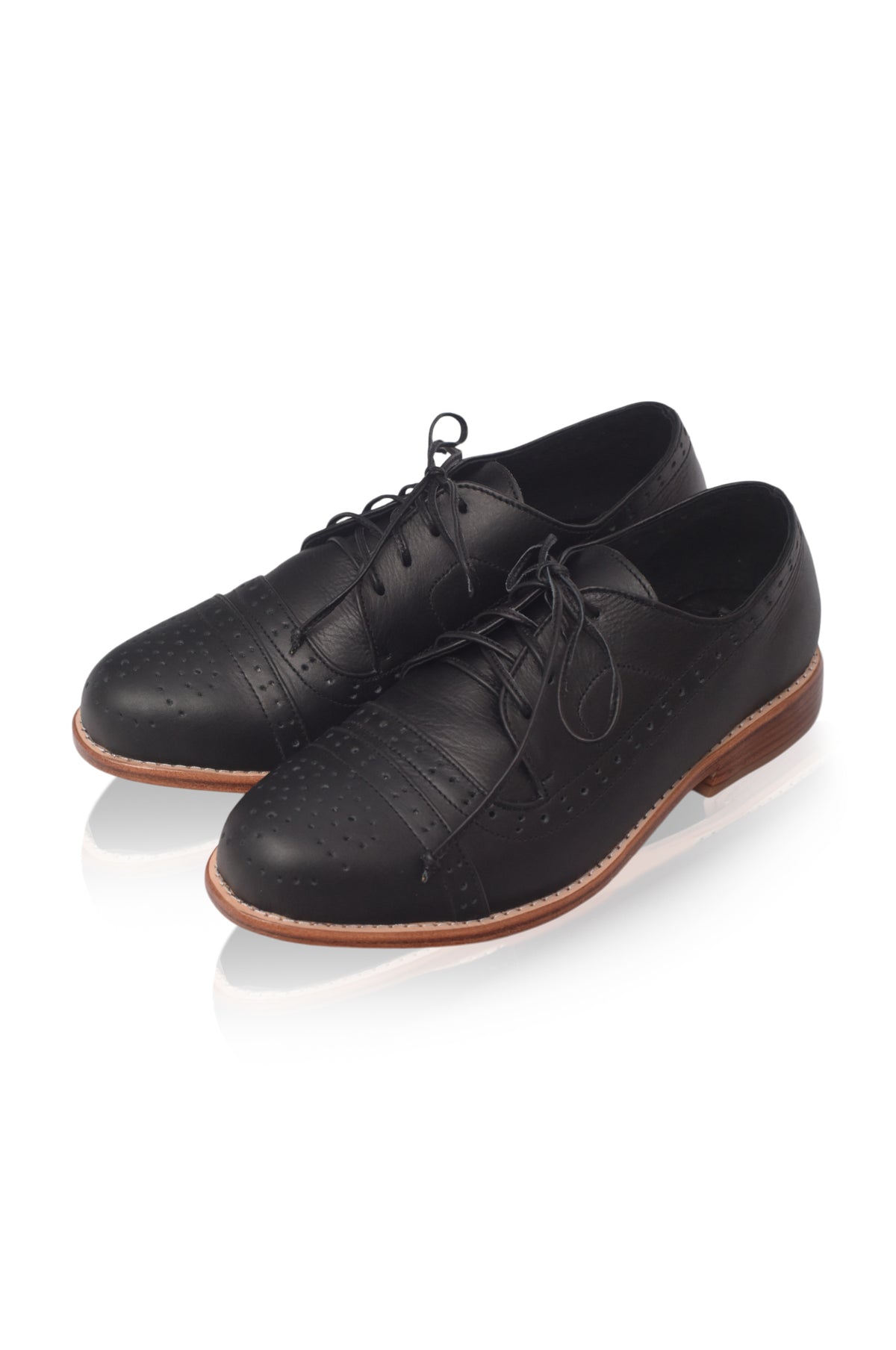 A pair of black leather lace-up oxford shoes with brogue detailing and a brown sole, displayed on a clean white background.