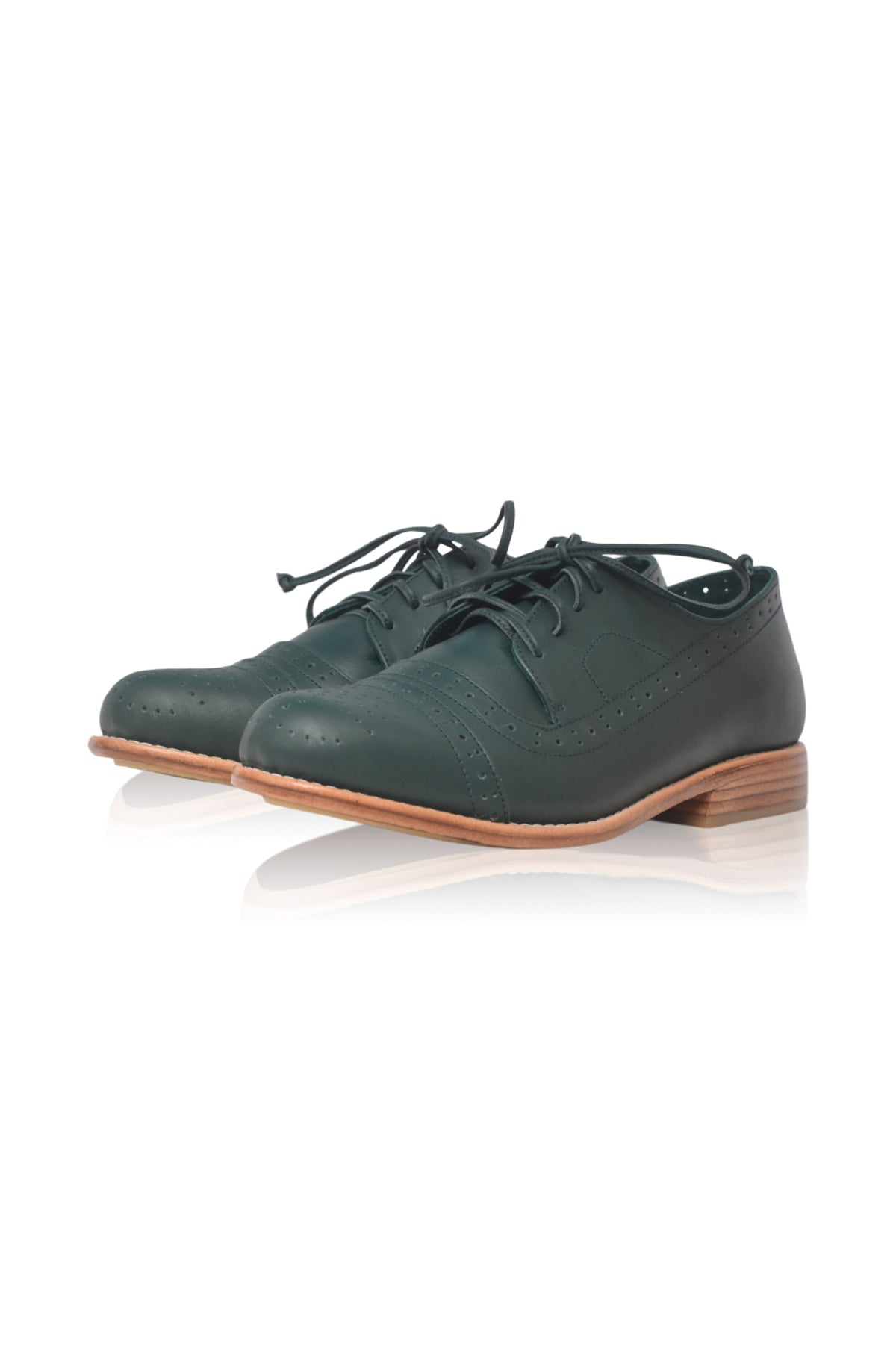 A pair of dark green leather lace-up shoes with a low stacked heel and light brown sole, shown on a white background with a soft reflection.