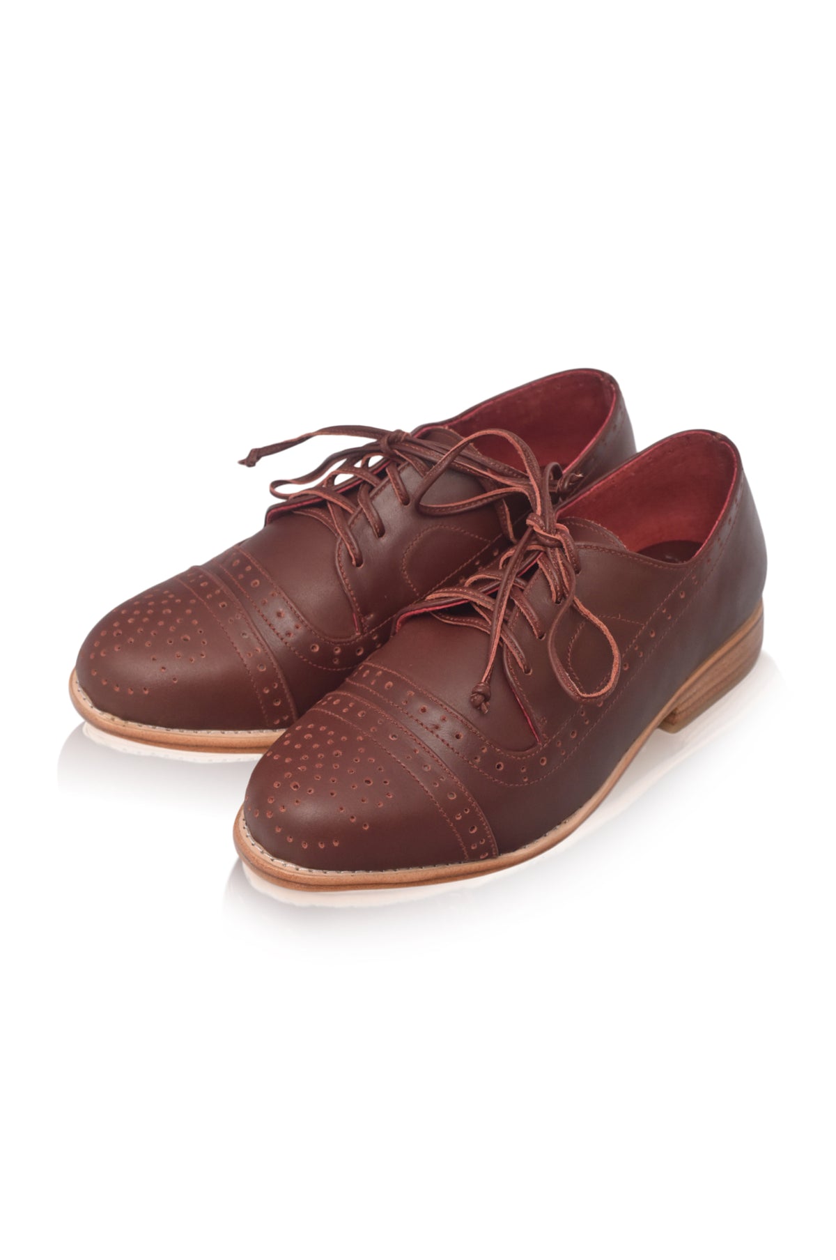 A pair of dark brown leather cap-toe oxford shoes with decorative brogue perforations, shown on a clean white background.