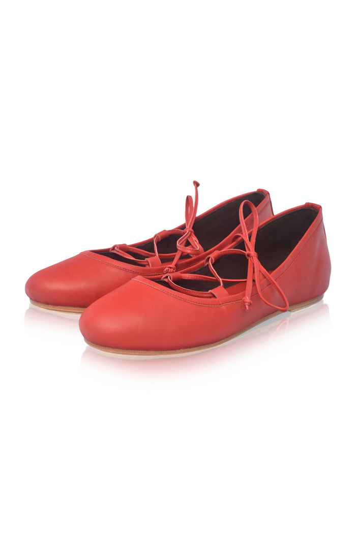 A pair of red leather lace-up flats with a low heel, displayed on a clean white background.