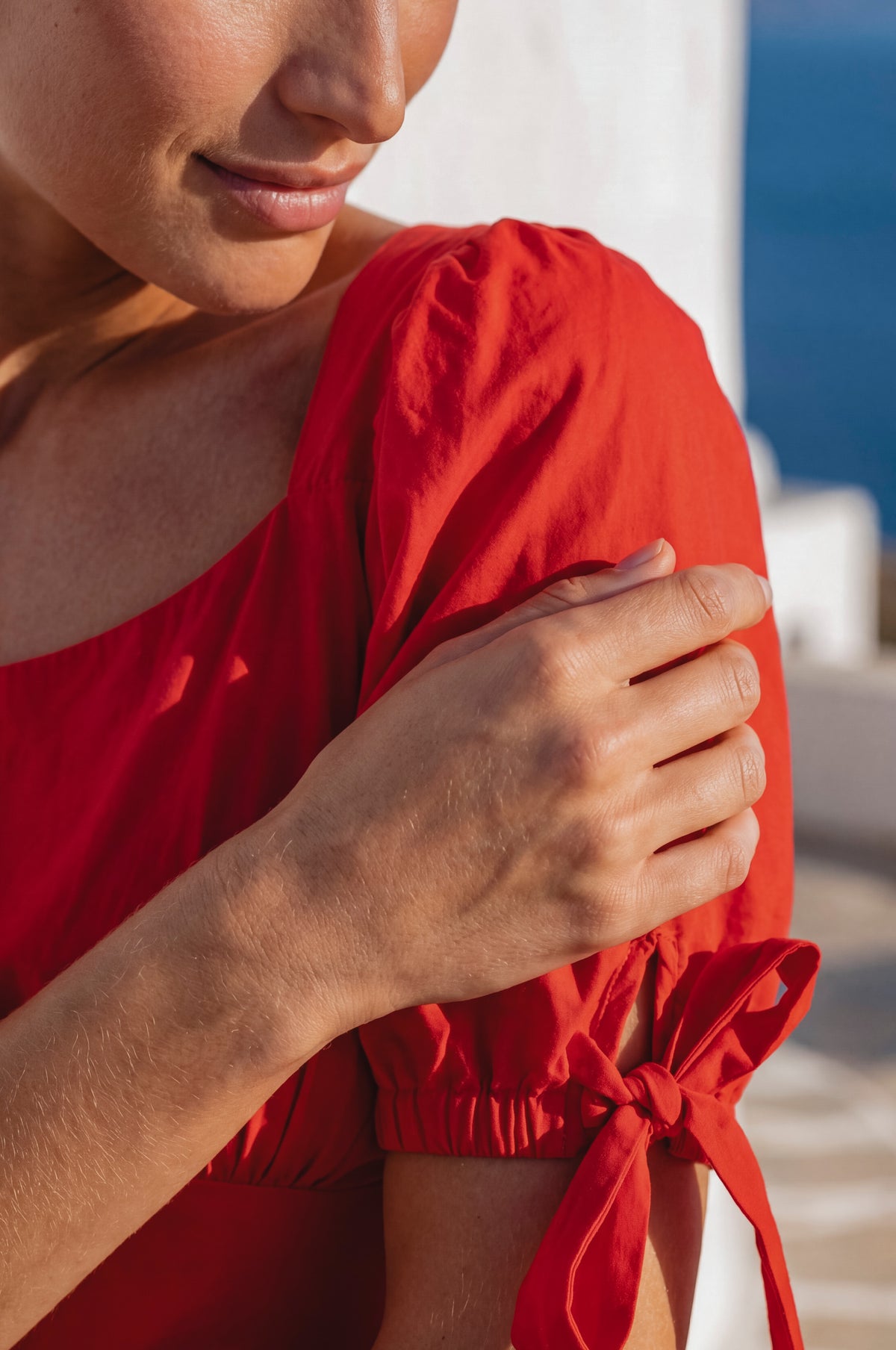 Person wearing a red dress with a blurred background