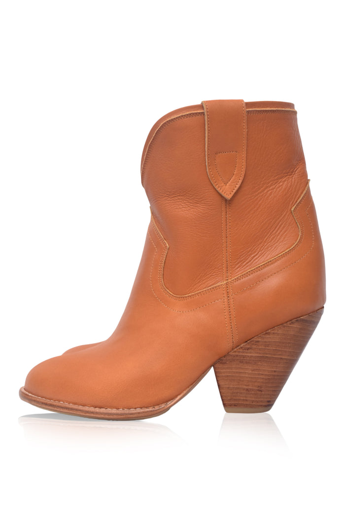 Tan leather ankle boot with wooden heel on a white background