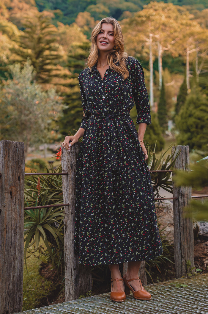 Woman in a floral dress standing in a garden