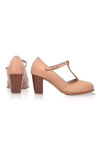 Pair of beige high-heeled shoes with wooden soles on a white background