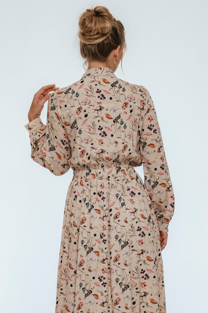 Woman wearing a floral dress with a plain background