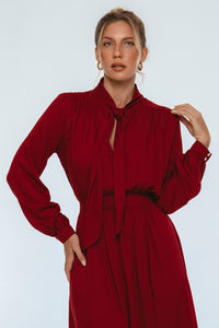 Woman wearing a red dress against a white background