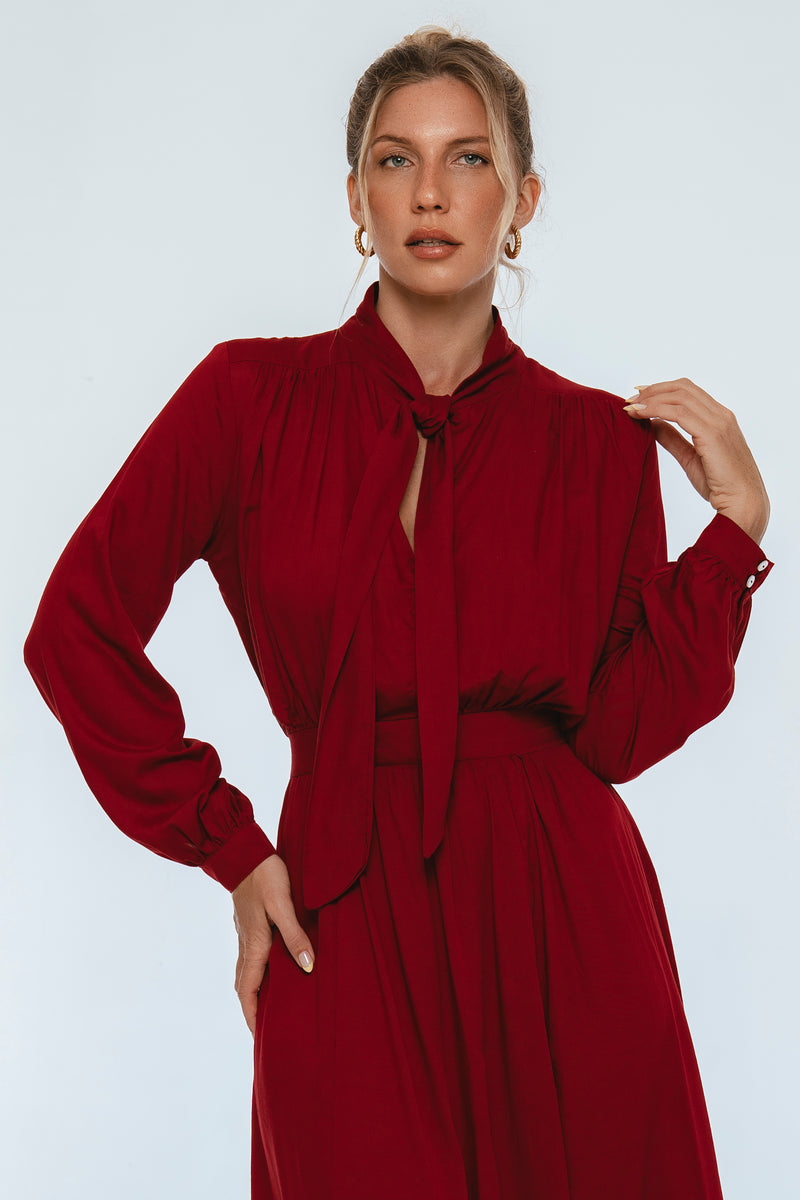 Woman wearing a red dress against a white background