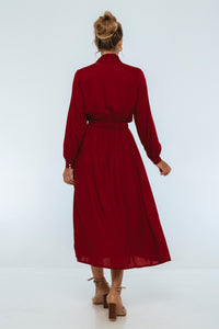 Red dress worn by a person on a white background