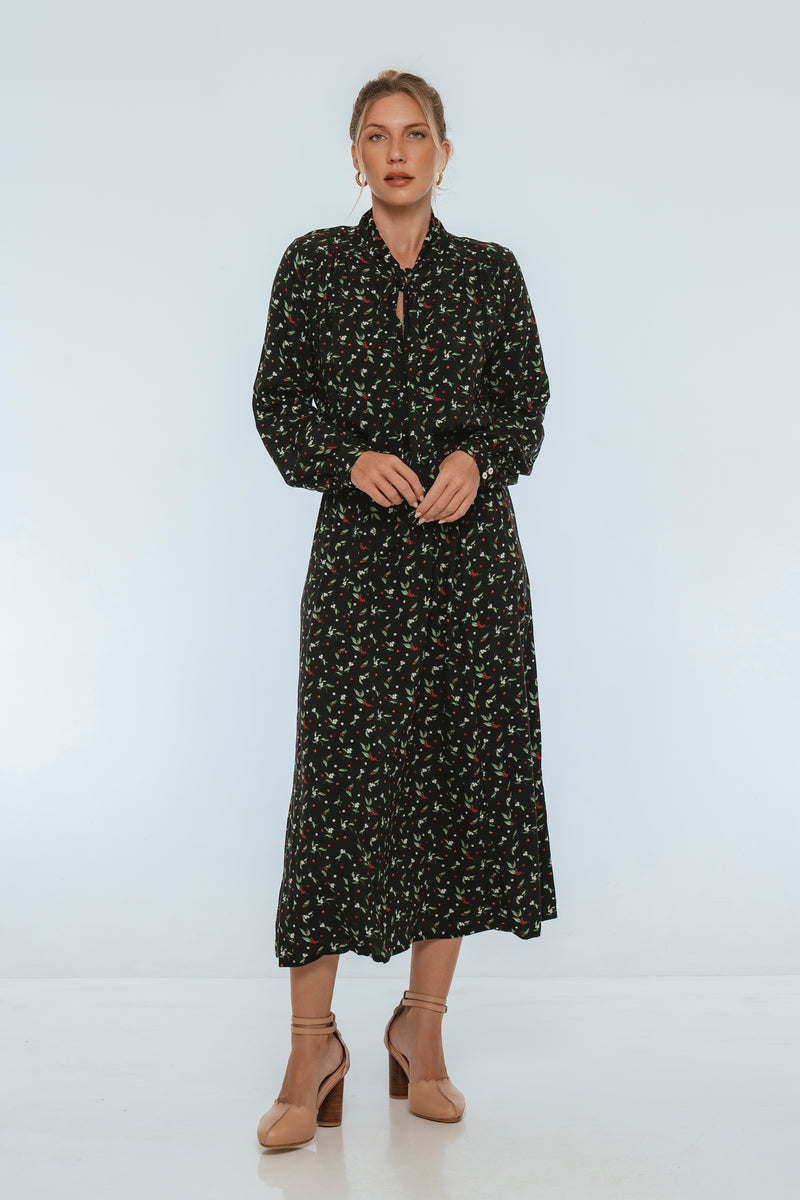 Woman wearing a black floral dress on a white background