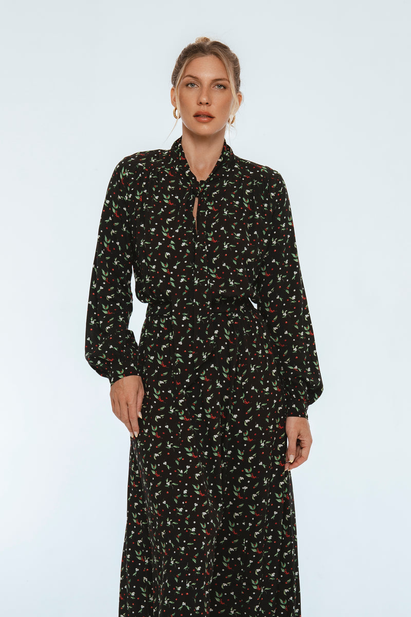 Woman wearing a black floral dress on a white background
