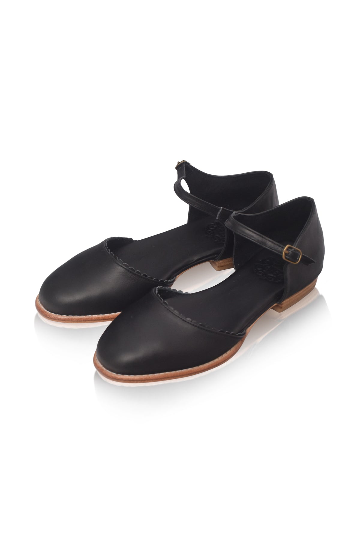 A pair of black leather Mary Jane dance shoes with ankle straps and small gold-tone buckle details, displayed on a clean white background.