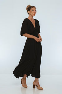 Woman wearing a black dress on a white background