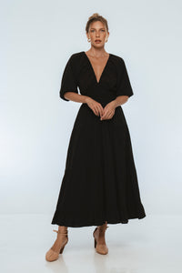 Woman wearing a black dress on a white background