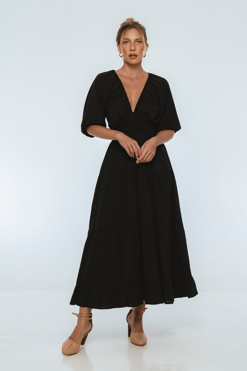 Woman wearing a black dress on a white background