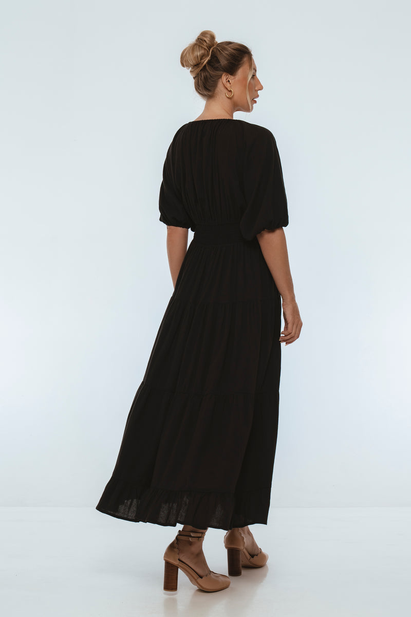 Woman wearing a black dress on a white background