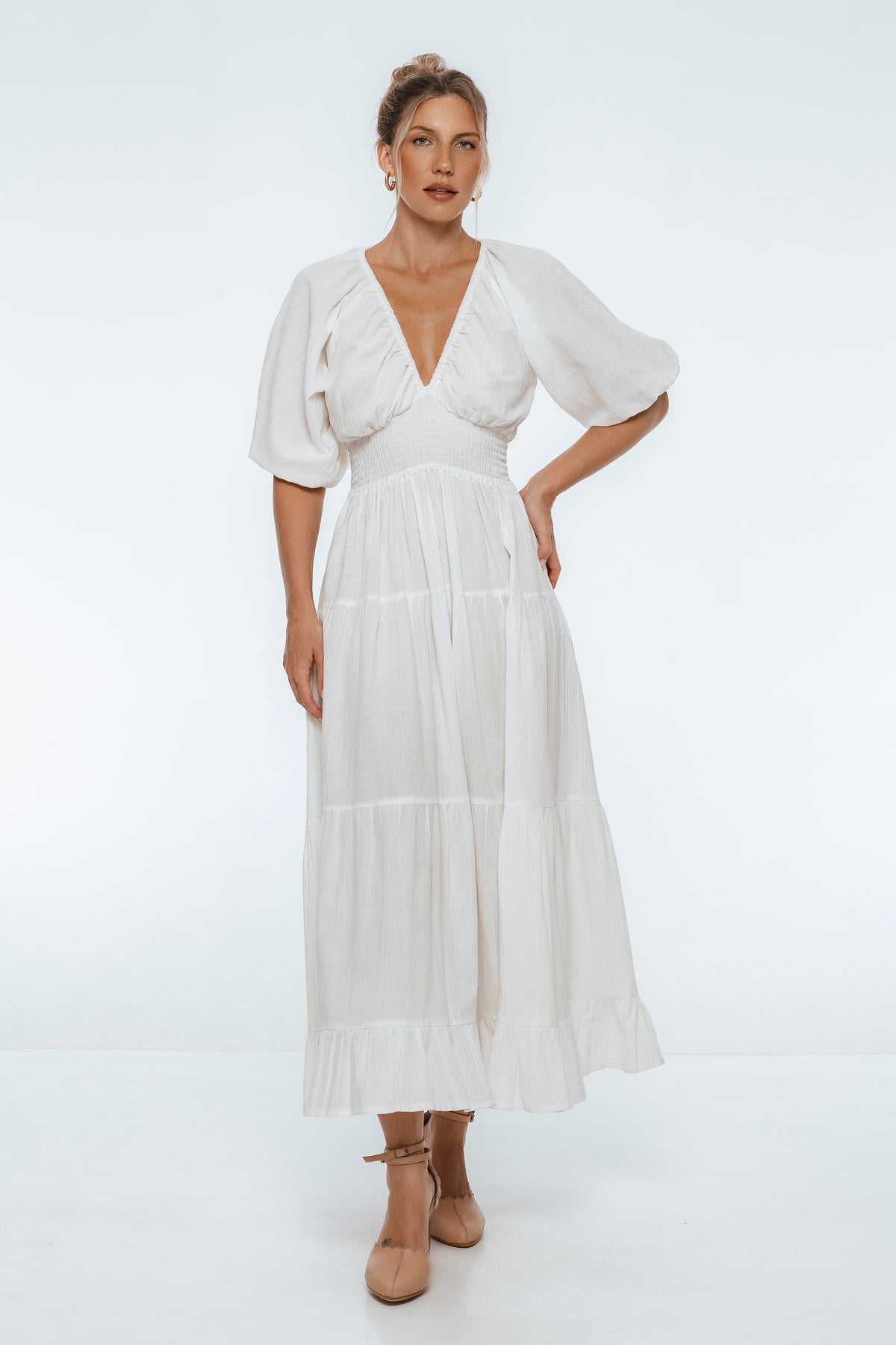 Woman wearing a white dress on a white background
