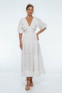 Woman wearing a white dress on a white background