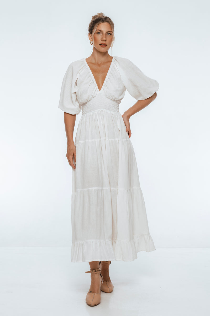 Woman wearing a white dress on a white background