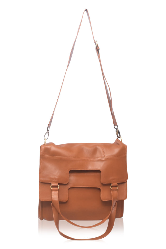 Brown leather bag with a strap on a white background