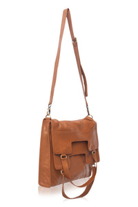 Brown leather handbag with a strap on a white background