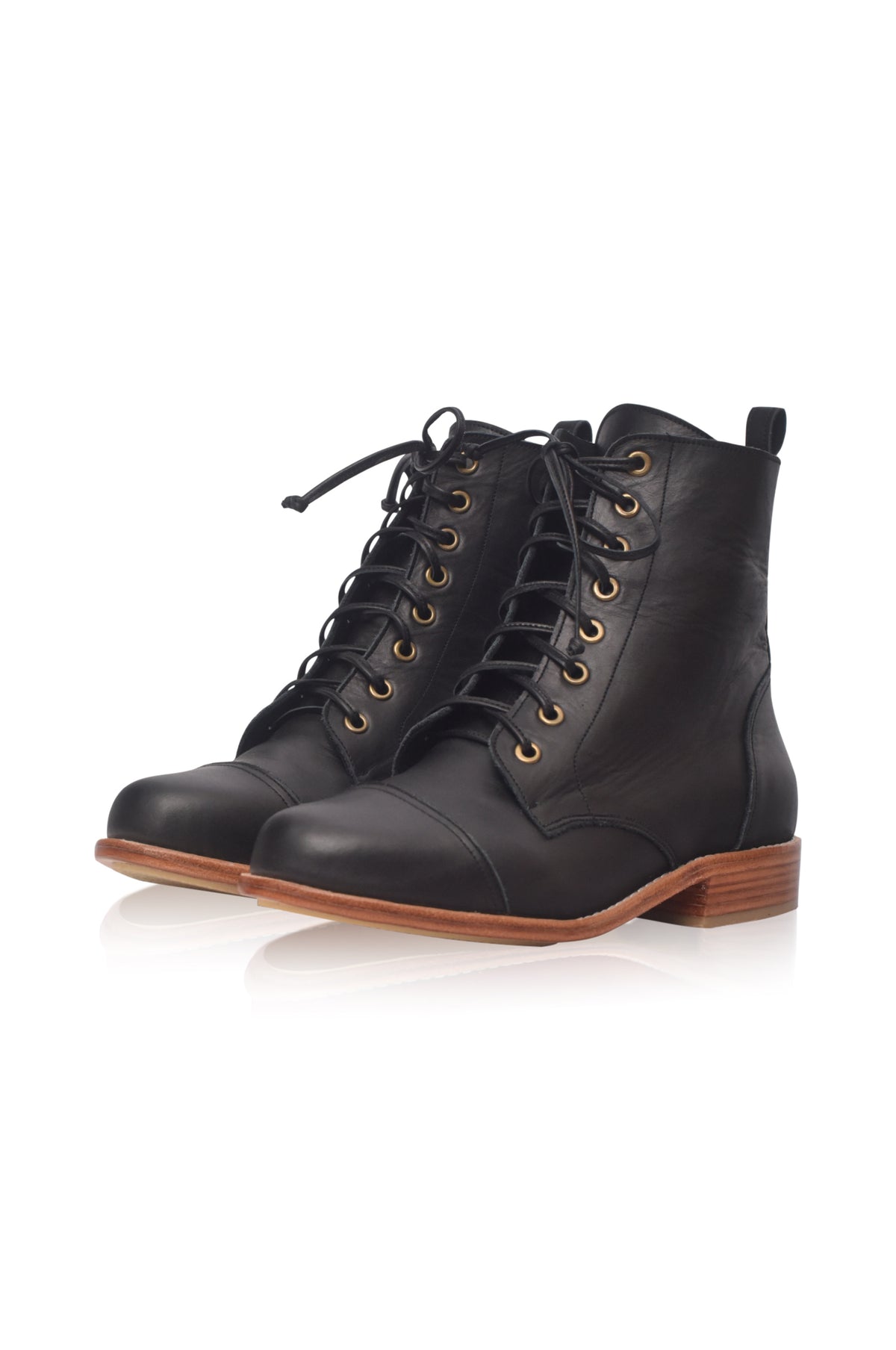 A pair of black leather lace-up combat boots with gold-tone eyelets and a brown stacked sole, shown on a clean white background.