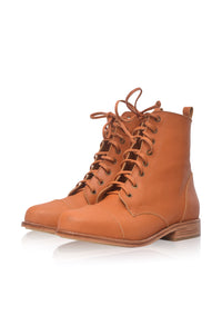 A pair of tan leather lace-up ankle boots with a low stacked heel, shown on a clean white background with a soft reflection.