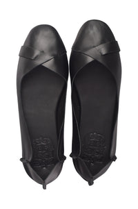 A pair of black leather ballet flats shown from a top-down view, featuring a criss-cross strap design across the toes and a low wedge heel, set against a plain white background.