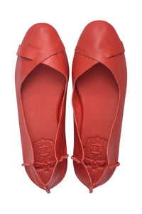 A pair of red leather ballet flats with a crossover strap across the instep, shown from a top-down view on a white background.