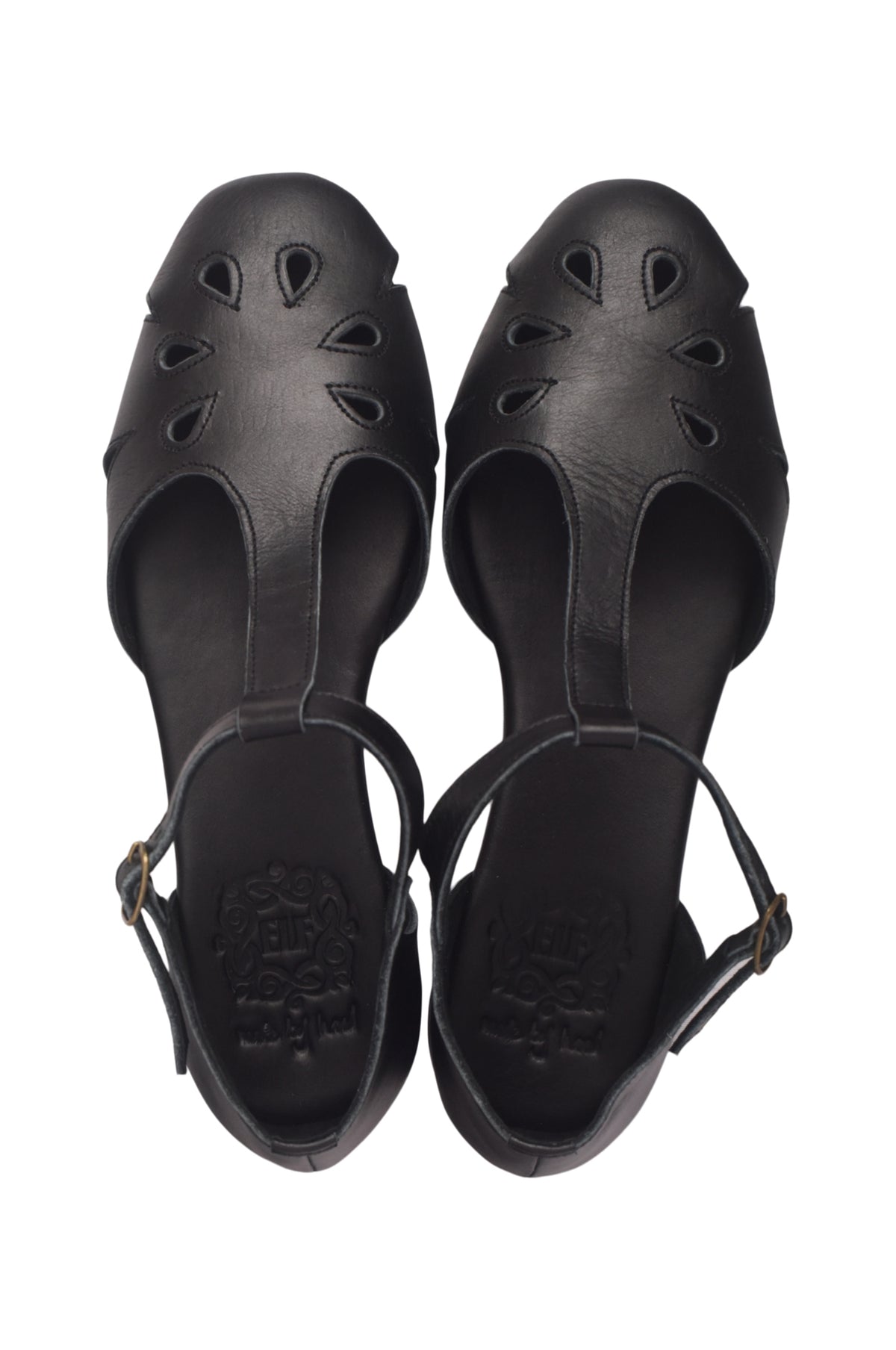A pair of black leather slide sandals with decorative cutouts on the toe and a thin ankle strap, shown from a top-down view on a white background.