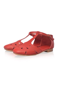 A pair of red leather T-strap sandals with cutout details on the toe and sides, shown against a plain white background.