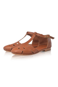 Brown suede dress shoe with a buckle on a white background