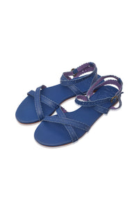 A pair of blue leather flat sandals with crisscrossing straps and adjustable ankle straps, shown on a plain white background.