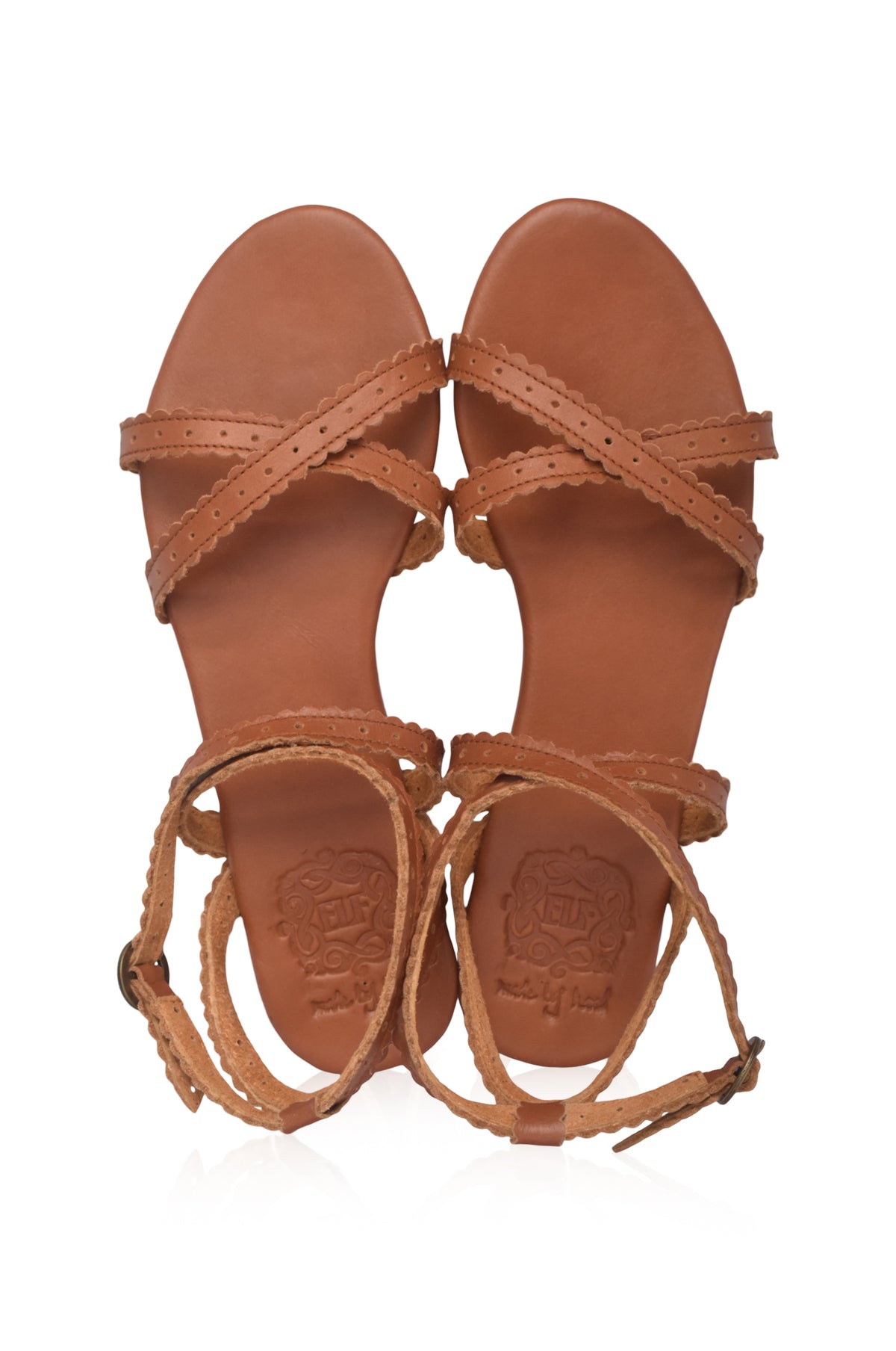 A pair of tan leather strappy sandals with braided heel straps, shown from a top-down view on a white background.