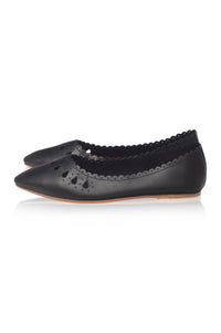 A pair of black leather ballet flats with pointed toes, decorative perforations, and a scalloped edge, shown against a plain white background.