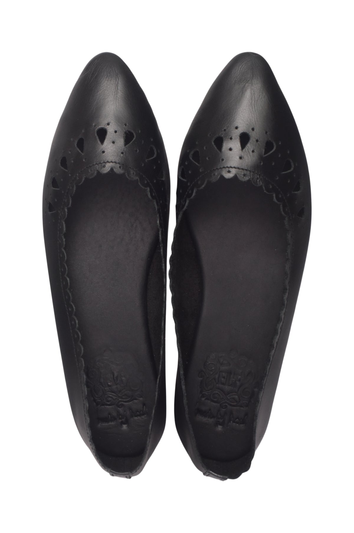 A pair of black leather pointed-toe flats with decorative cutout detailing on the vamp, shown from a top-down view on a white background.