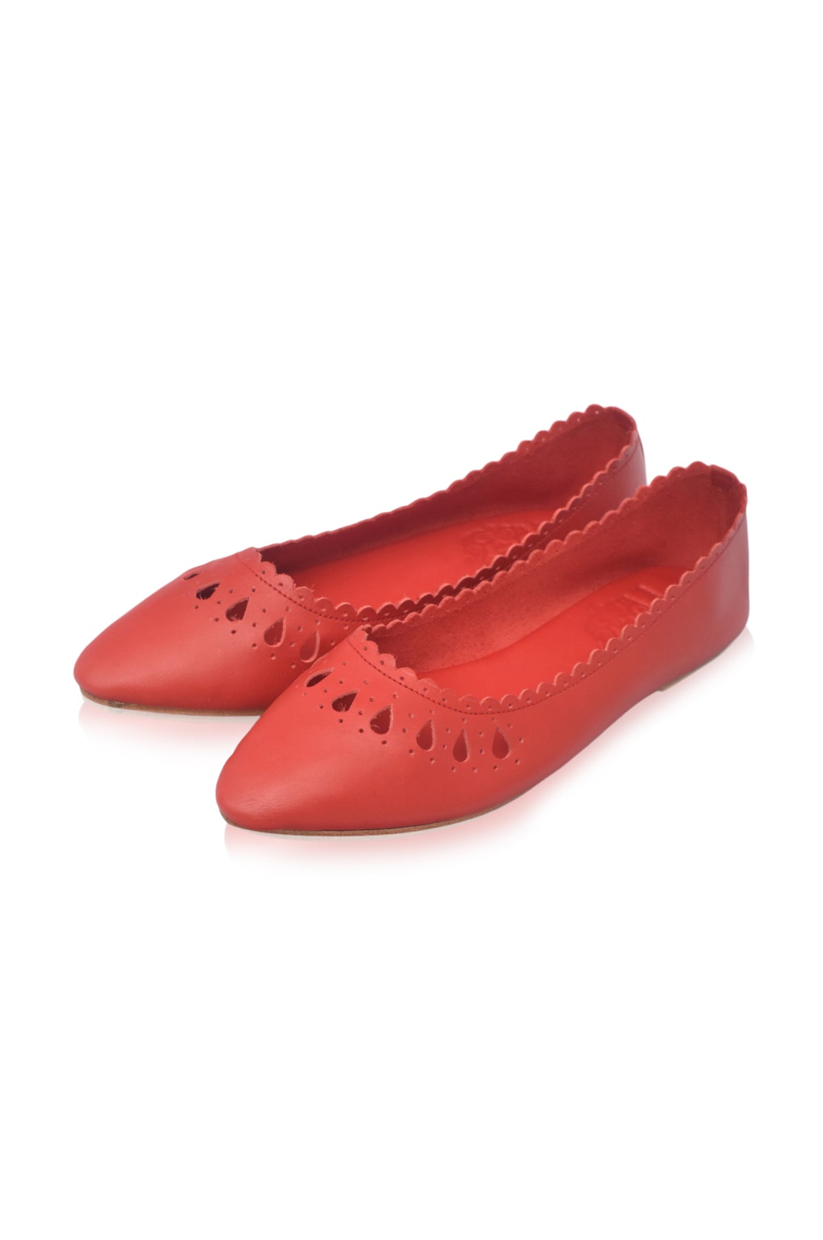 A pair of red pointed-toe flats with scalloped edges and decorative cutouts on the toe, shown on a plain white background.
