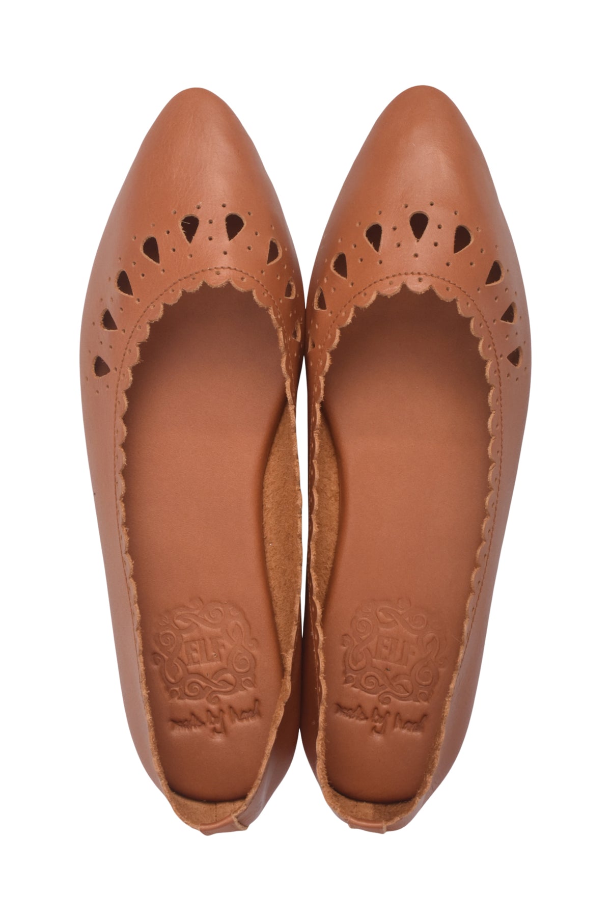 A pair of tan leather pointed-toe flats with decorative cutout detailing along the vamp, shown from a top-down view on a white background.