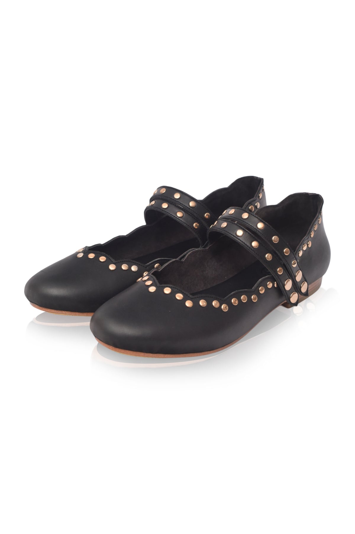 Black shoes with gold studs on a white background