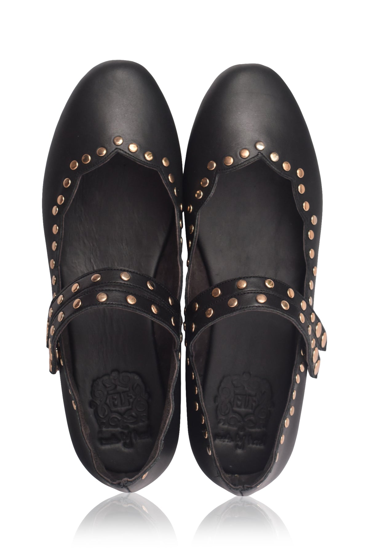 Pair of black leather shoes with gold studs on a white background.