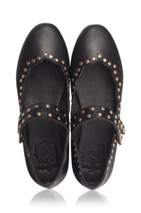 Pair of black leather shoes with gold studs on a white background.