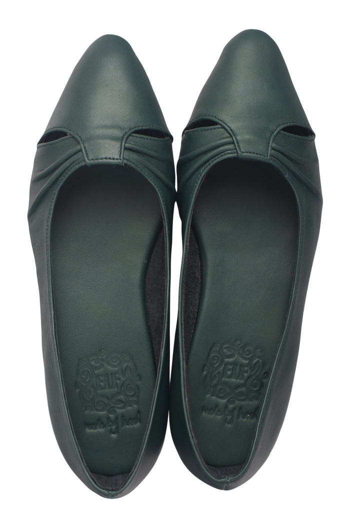 Pair of green shoes with cut-out design on a white background