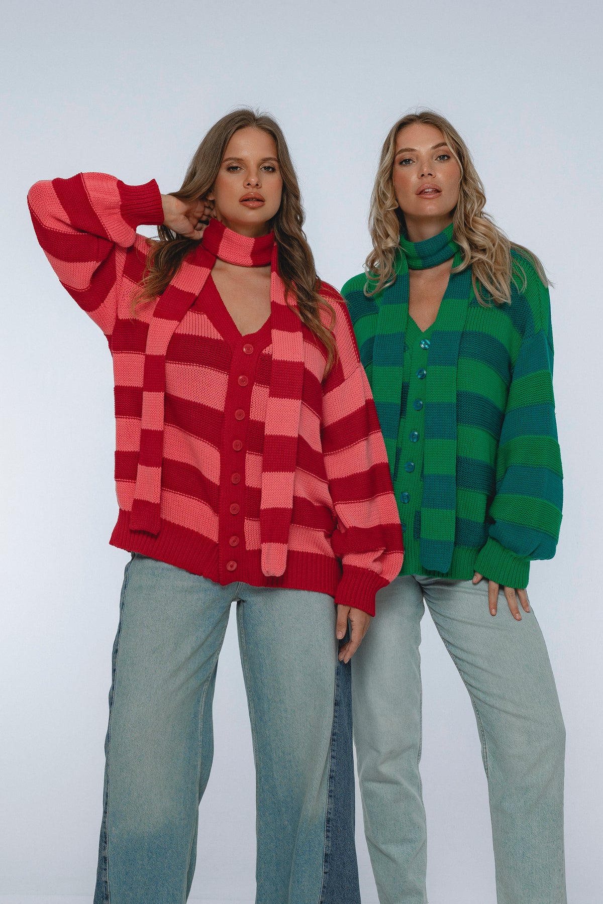 Two women wearing colorful checkered shirts against a white background