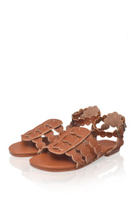 Brown sandal with floral cut-out design on a white background
